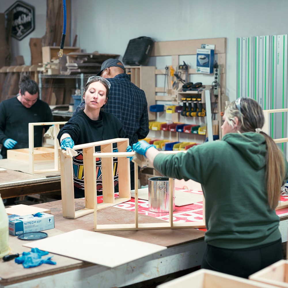 Woodworking students work together on their projects