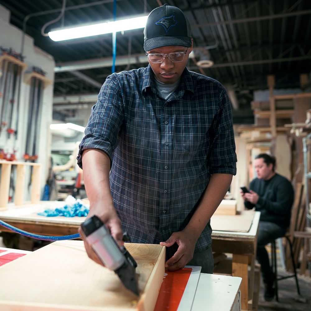 Woodworking student working on his final project