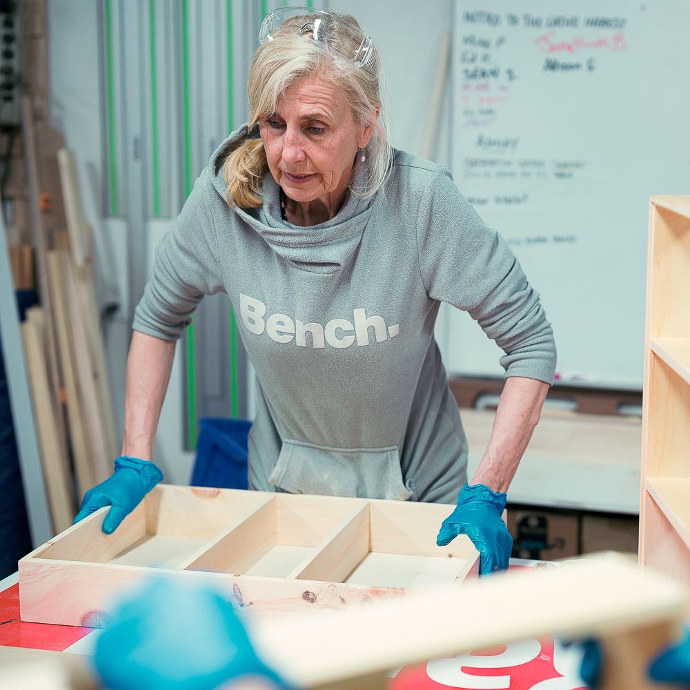 Woodworking 101 student with her finished project